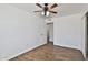 Minimalist bedroom featuring white walls, wood-look flooring and a ceiling fan at 811 W Northern Ave, Phoenix, AZ 85021