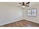 Simple bedroom featuring a ceiling fan, wood-look floors, and lots of natural light at 811 W Northern Ave, Phoenix, AZ 85021