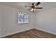 Bright bedroom with wood-look floors, a ceiling fan, and a large window at 811 W Northern Ave, Phoenix, AZ 85021
