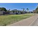 Charming single-story home with a lush green lawn and mature palm trees offering nice curb appeal at 811 W Northern Ave, Phoenix, AZ 85021