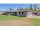 Gray house with a spacious lawn, attached garage, and red front door at 811 W Northern Ave, Phoenix, AZ 85021
