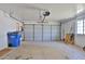 Spacious two-car garage with a newer garage door, storage shelves, and painted drywall at 811 W Northern Ave, Phoenix, AZ 85021