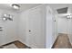 Inviting hallway with wood-look floors and a bright white front door and additional interior access door at 811 W Northern Ave, Phoenix, AZ 85021
