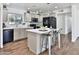 Updated kitchen with stainless steel appliances, a center island, and wood-look flooring for a modern look at 811 W Northern Ave, Phoenix, AZ 85021