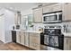 Bright kitchen featuring stainless steel appliances, updated cabinets, and white countertops at 811 W Northern Ave, Phoenix, AZ 85021