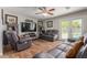 Living room with leather furniture, hardwood floors, and pool view at 811 W Northern Ave, Phoenix, AZ 85021