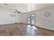 Open living room with double doors leading to the backyard and wood-look tile flooring at 811 W Northern Ave, Phoenix, AZ 85021