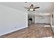 Spacious living room with kitchen in the background, featuring wood-look tile flooring at 811 W Northern Ave, Phoenix, AZ 85021