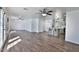 Spacious living room with wood-look tile flooring and an open layout to the kitchen at 811 W Northern Ave, Phoenix, AZ 85021