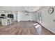Open layout living room with wood-look tile floors and a view of the updated kitchen at 811 W Northern Ave, Phoenix, AZ 85021