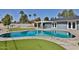 Backyard pool with mature landscaping and a covered patio with a table and chairs at 811 W Northern Ave, Phoenix, AZ 85021