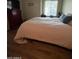 Comfortable bedroom with a full-size bed and wood-look flooring at 8140 N 107Th Ave # 99, Peoria, AZ 85345