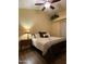 Bright bedroom with a queen-size bed, nightstand, and ceiling fan at 8140 N 107Th Ave # 99, Peoria, AZ 85345
