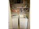 Laundry closet with washer, dryer, and storage shelves at 8140 N 107Th Ave # 99, Peoria, AZ 85345