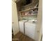Laundry closet with washer, dryer, and storage shelves at 8140 N 107Th Ave # 99, Peoria, AZ 85345