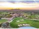 Expansive aerial view of a luxury community featuring manicured golf courses, lush greenery, and elegant architecture at 8260 E Sunset View Dr, Gold Canyon, AZ 85118