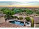 Breathtaking aerial view of a luxury home, community and pool overlooking mountains at 8260 E Sunset View Dr, Gold Canyon, AZ 85118