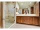 Well-lit bathroom featuring a double sink vanity, glass shower and tile flooring at 8260 E Sunset View Dr, Gold Canyon, AZ 85118