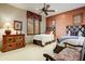 Comfortable guest bedroom with two twin beds, an accent wall, and wood furniture at 8260 E Sunset View Dr, Gold Canyon, AZ 85118