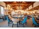Elegant dining room with wood beam ceilings, grand fireplace and large windows for natural light at 8260 E Sunset View Dr, Gold Canyon, AZ 85118