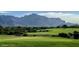 Lush golf course featuring a vibrant green landscape with a backdrop of mountains at 8260 E Sunset View Dr, Gold Canyon, AZ 85118