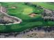 Aerial view of a vibrant golf course with sand traps, cart path and manicured greenery at 8260 E Sunset View Dr, Gold Canyon, AZ 85118