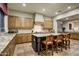 Gourmet kitchen boasts custom wood cabinets, granite countertops, tile backsplash, and an island with seating at 8260 E Sunset View Dr, Gold Canyon, AZ 85118