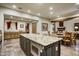 Spacious kitchen featuring granite countertops, custom cabinets, stainless steel appliances, and open dining area at 8260 E Sunset View Dr, Gold Canyon, AZ 85118