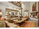 Spacious living room with fireplace, comfortable sofas, and beamed ceilings exudes rustic elegance at 8260 E Sunset View Dr, Gold Canyon, AZ 85118