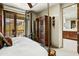 Bright main bedroom with a private balcony showcasing mountain views and adjacent bathroom at 8260 E Sunset View Dr, Gold Canyon, AZ 85118