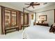 Calm bedroom with canopy bed, carpeted floor, bench seating and three windows at 8260 E Sunset View Dr, Gold Canyon, AZ 85118