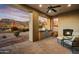 Outdoor patio with mountain views featuring a fireplace and outdoor cooking area at 8260 E Sunset View Dr, Gold Canyon, AZ 85118