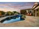 Beautiful backyard pool with waterfall feature, lush landscaping, and comfortable lounge chairs, creating a tranquil retreat at 8260 E Sunset View Dr, Gold Canyon, AZ 85118