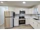 Updated kitchen featuring stainless steel appliances and white shaker cabinets at 849 W Mitchell Dr, Phoenix, AZ 85013