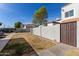 Side exterior view of townhome showing the walkway to the gated entry at 954 E Diamond Dr, Tempe, AZ 85283