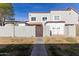 Back exterior view of townhome with private gated entry and small patio at 954 E Diamond Dr, Tempe, AZ 85283
