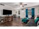 Living room with sectional sofa, wood floors, and a large TV at 954 E Diamond Dr, Tempe, AZ 85283