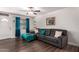 Living room boasts a sectional sofa, wood-look floors, and teal accents at 954 E Diamond Dr, Tempe, AZ 85283