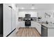 Modern kitchen with white cabinets, granite counters, and stainless steel appliances at 10366 W Camelia Dr, Arizona City, AZ 85123