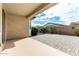 Covered patio with patterned brick, opening to private, walled backyard with desert landscaping at 1081 W Brangus Way, San Tan Valley, AZ 85143