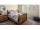 Cozy bedroom featuring a wooden bed frame, soft carpet, and bright natural light at 1081 W Brangus Way, San Tan Valley, AZ 85143