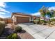 Tan single-story home with a tile roof, desert landscaping and a wide driveway at 1081 W Brangus Way, San Tan Valley, AZ 85143