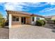 Rear exterior shot of the home featuring a covered patio, tile roof, and desert landscaping at 1081 W Brangus Way, San Tan Valley, AZ 85143