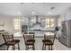 Bright kitchen with a large granite island, stainless steel appliances, and ample cabinet space for storage at 1081 W Brangus Way, San Tan Valley, AZ 85143