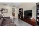 Cozy living room with hardwood floors, leather sofa, and modern entertainment center at 1081 W Brangus Way, San Tan Valley, AZ 85143