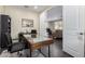 Bright home office with a modern desk and an open view into the living room at 1081 W Brangus Way, San Tan Valley, AZ 85143