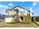 Two-story house with a white exterior, green accents, and a brick facade at 1112 W Citation Dr, Chandler, AZ 85224