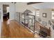 Upstairs hallway with wood floors and wrought iron railing at 1112 W Citation Dr, Chandler, AZ 85224