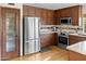 Modern kitchen with dark wood cabinets, stainless steel appliances, and granite countertops at 1112 W Citation Dr, Chandler, AZ 85224