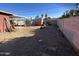 Backyard view with storage shed and dirt at 11217 W Missouri Ave, Youngtown, AZ 85363